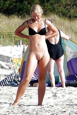 beautiful nudist girlfriend sunbathes without bikini by the sea